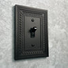 Filigree Border Matte Black Cast - 3 Toggle Wallplate